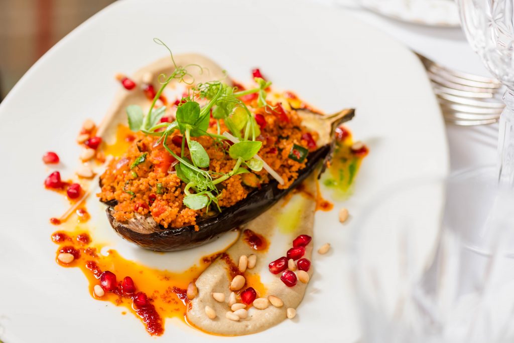 aubergine with cous cous pomegranates and pine nuts