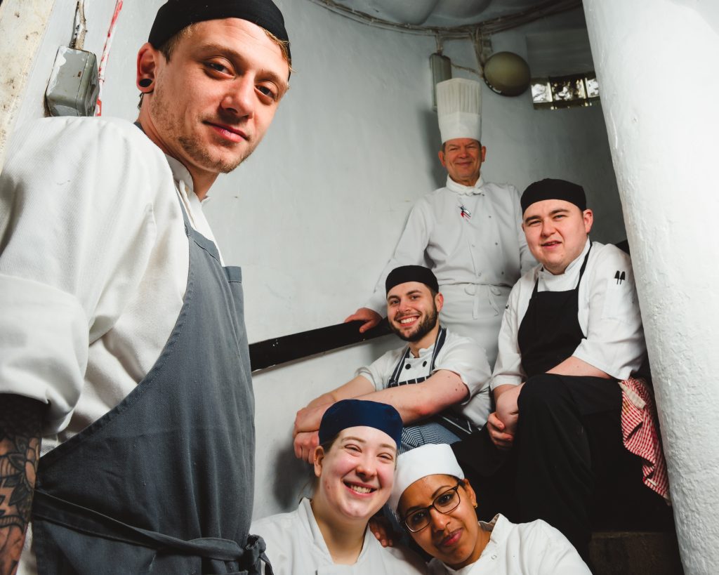 Chef Stephen Johnson and his team on a stairwell in The Buttery Glasgow