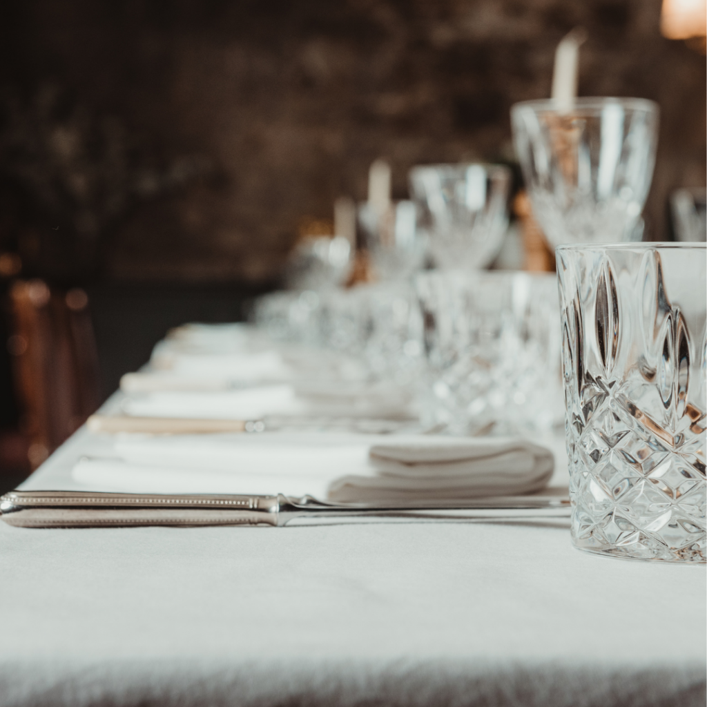 Glasses and table settings on a table in The Belles at The Buttery