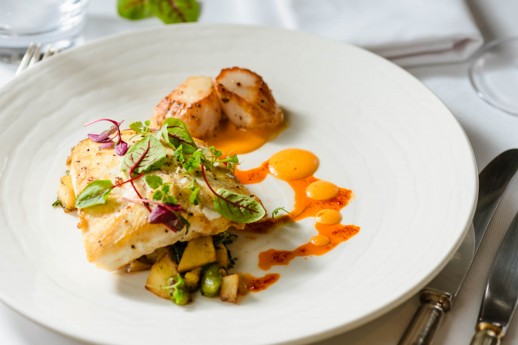 fillet of halibut with scallops and a sorrel garnish