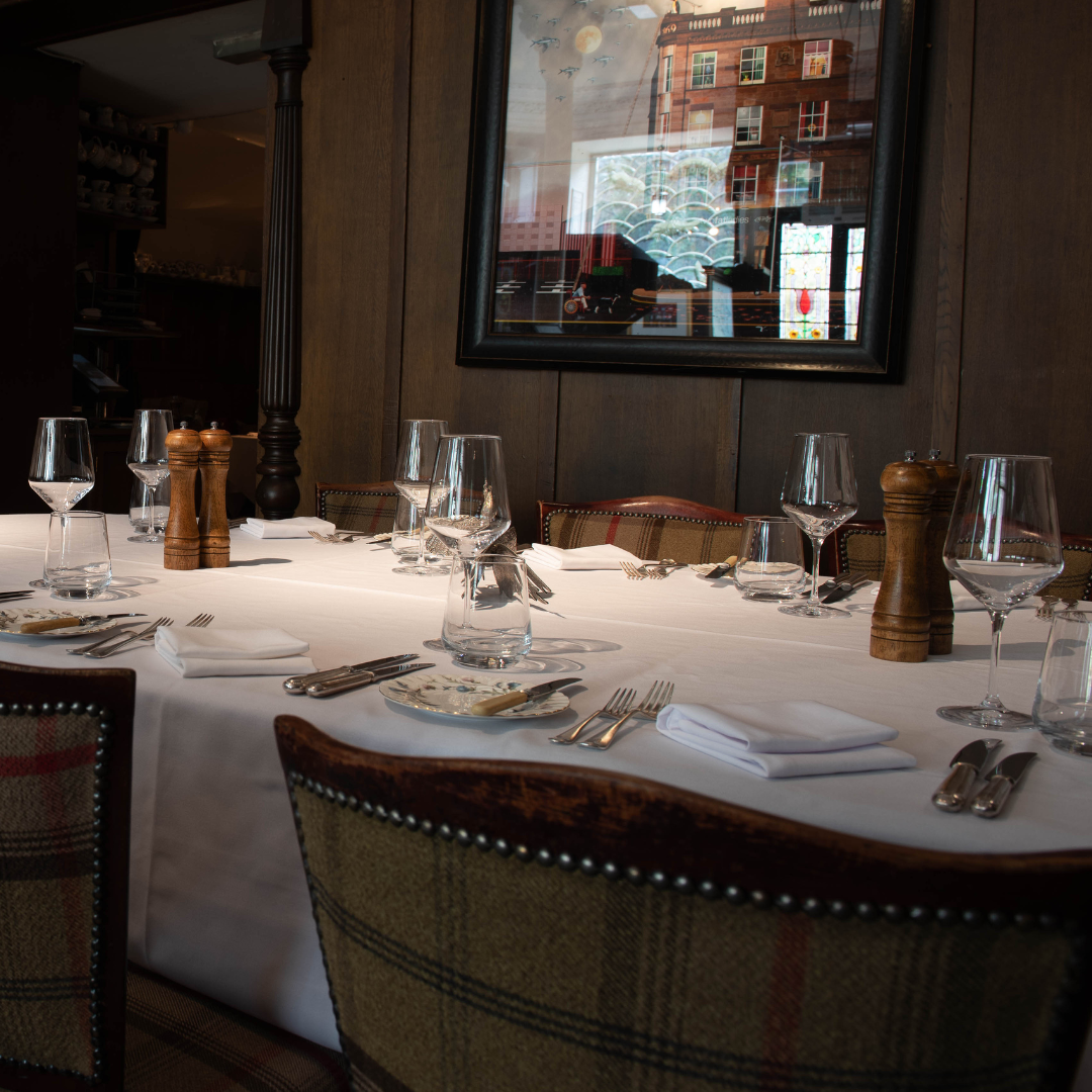 a large table for eight in the main dining room at the buttery in glasgow